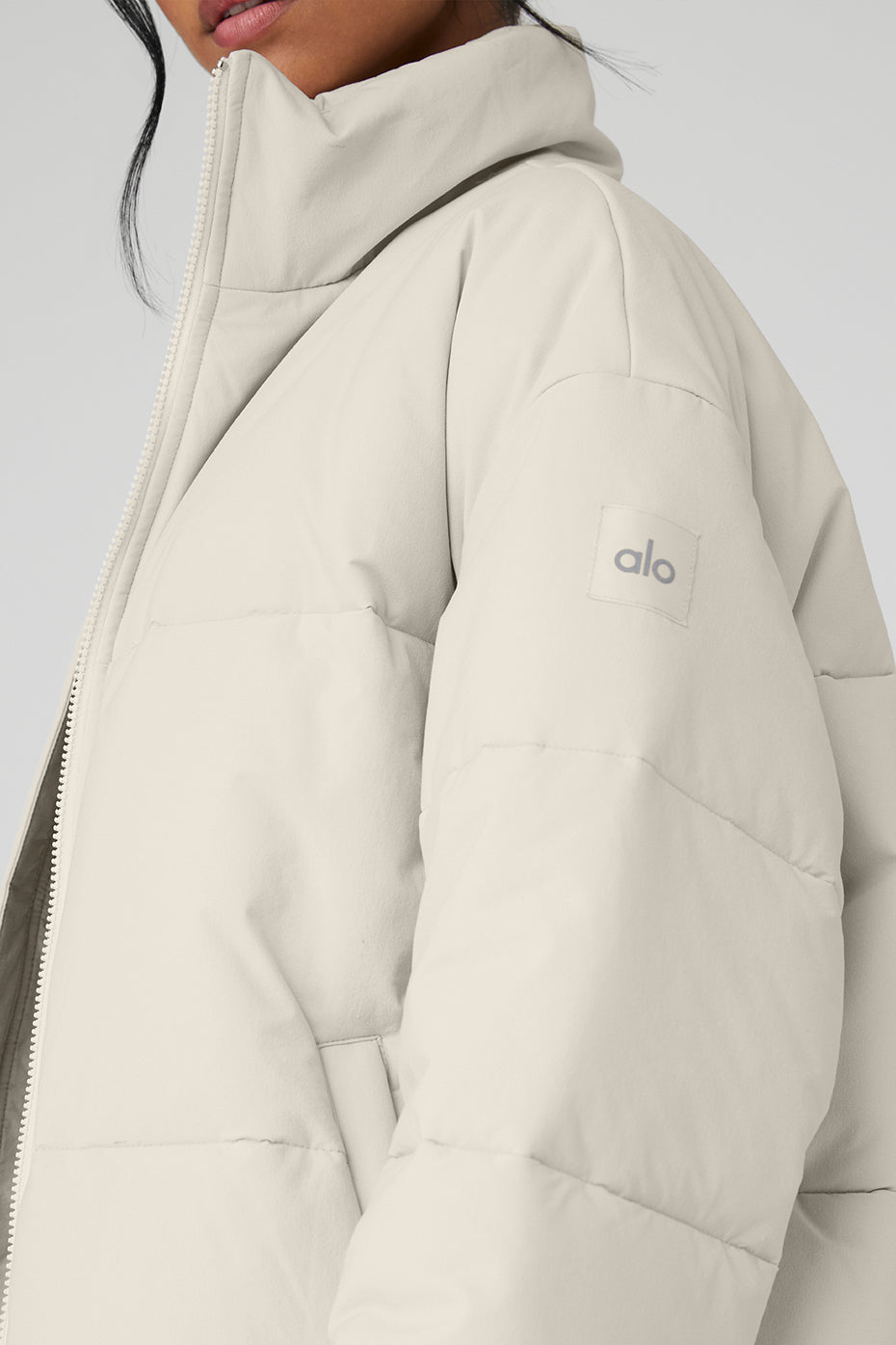 Model wearing the bone puffer jacket with a layered look for urban style.