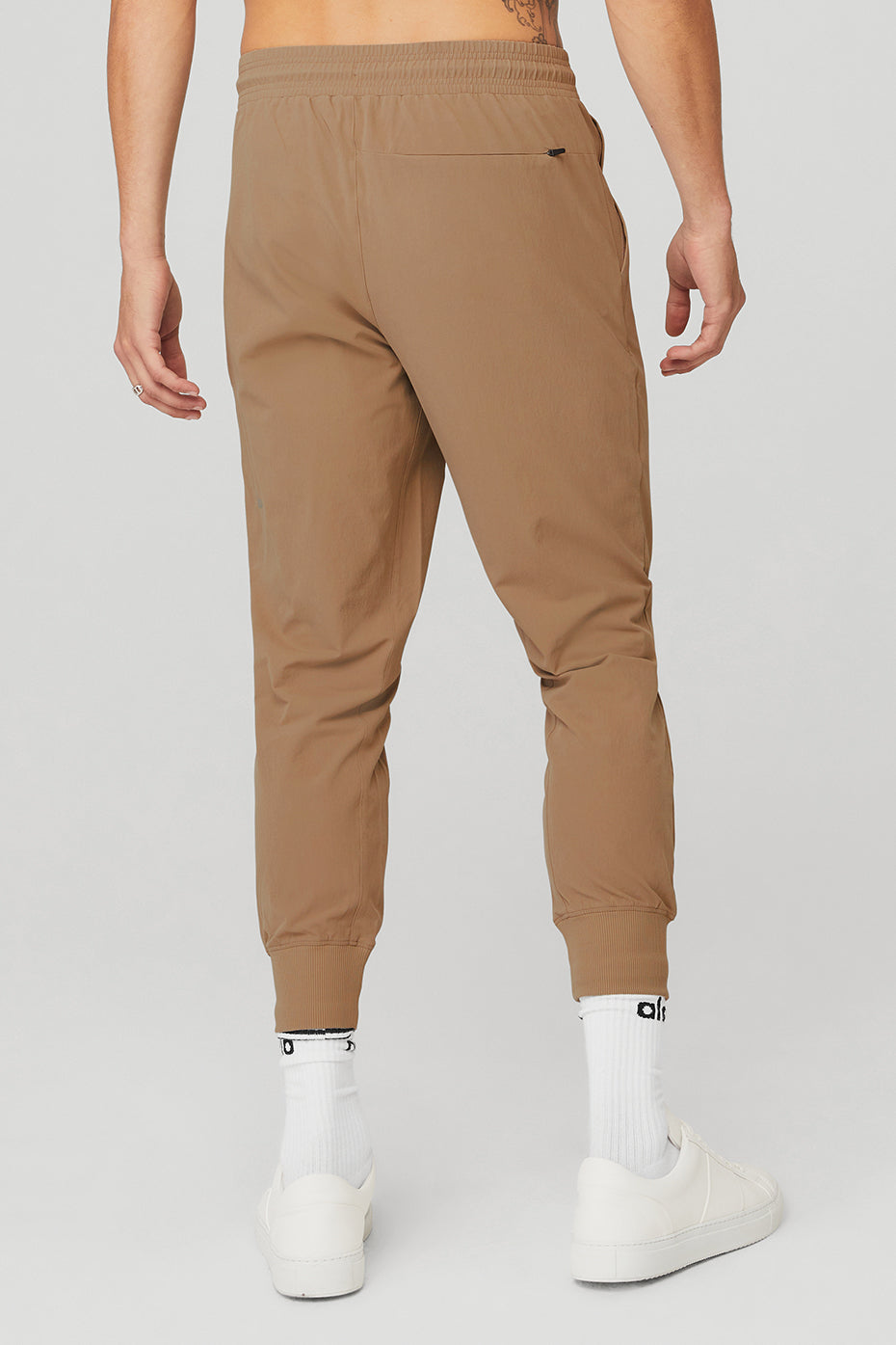 Side view of lightweight activewear pants with zip pockets.