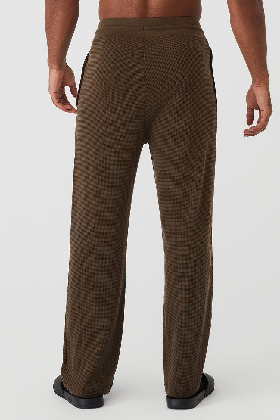 Close-up of the elastic waistband and zippered pockets of the joggers.