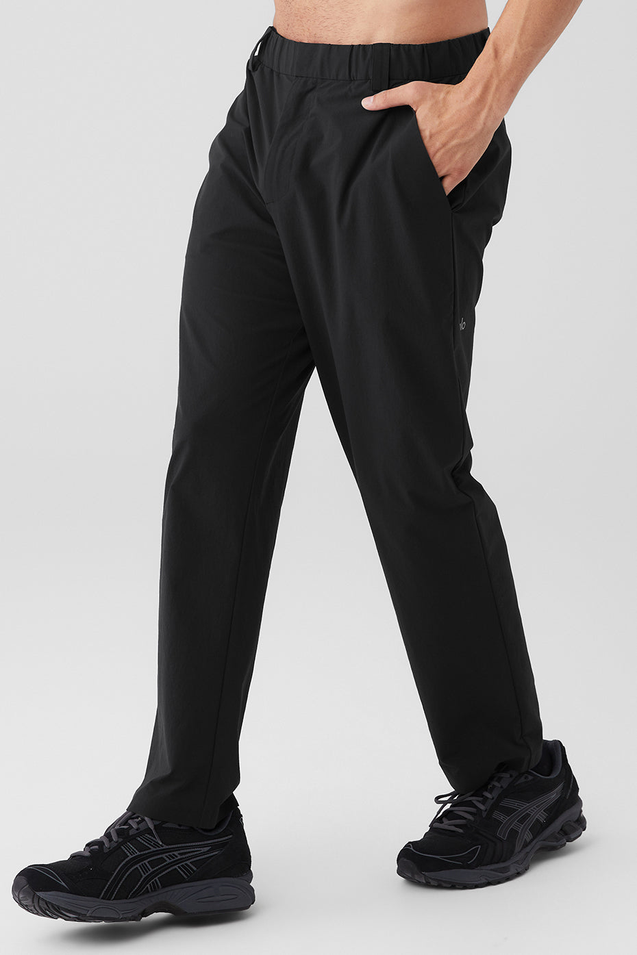 Side view of black tailored pants featuring elevated seams and belt loops
