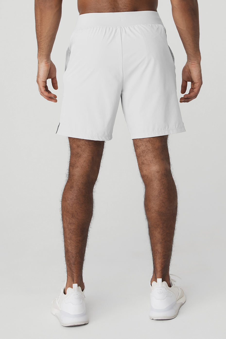 Side profile of performance shorts showing faux-fly detail and subtle slit for airflow