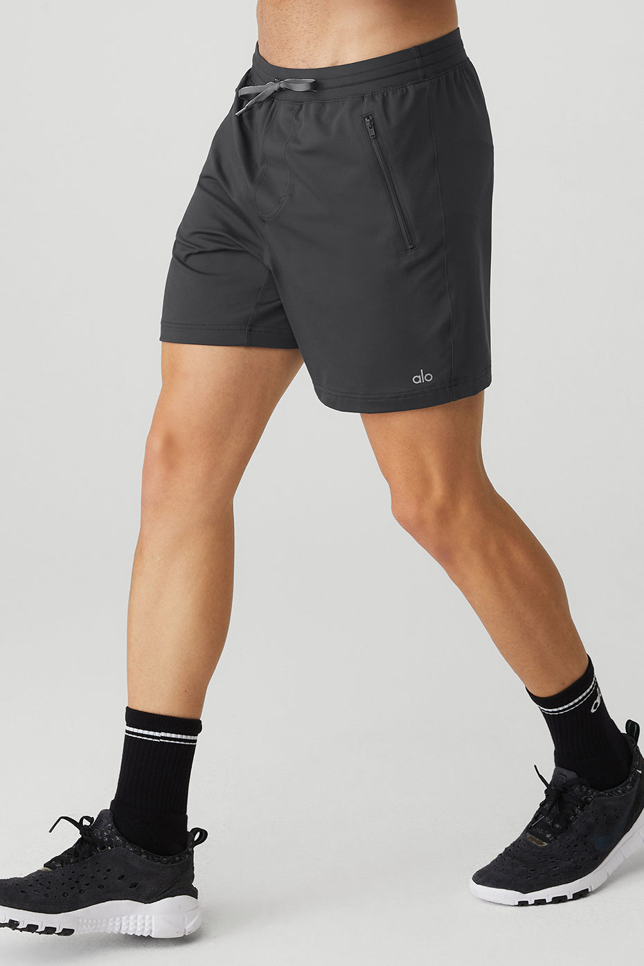 Model walking downtown Minneapolis in casual shorts and pullover hoodie