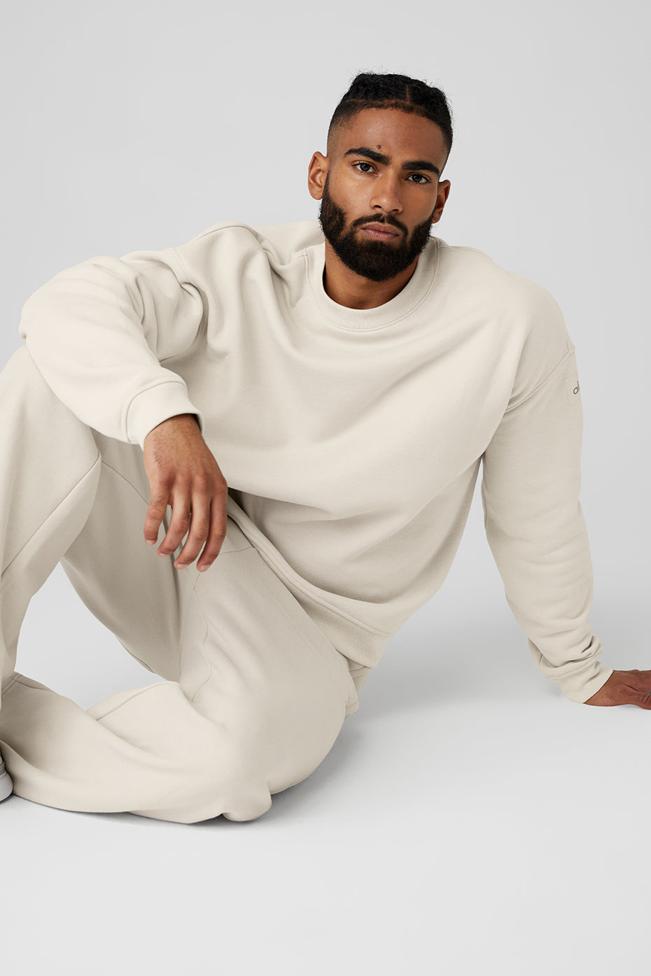 Lifestyle shot showcasing the black crew neck pullover worn outdoors.
