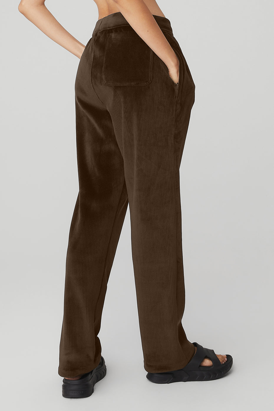 Close-up of the elastic waistband and pockets on the velour pants.