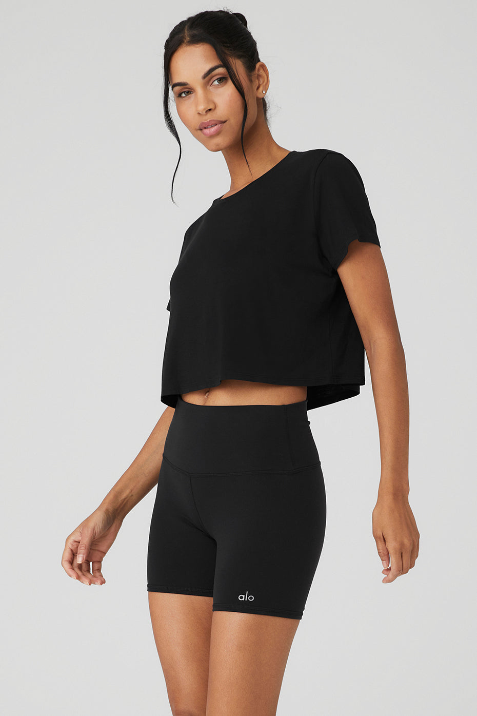 Casual outfit featuring a black cropped t-shirt paired with shorts.