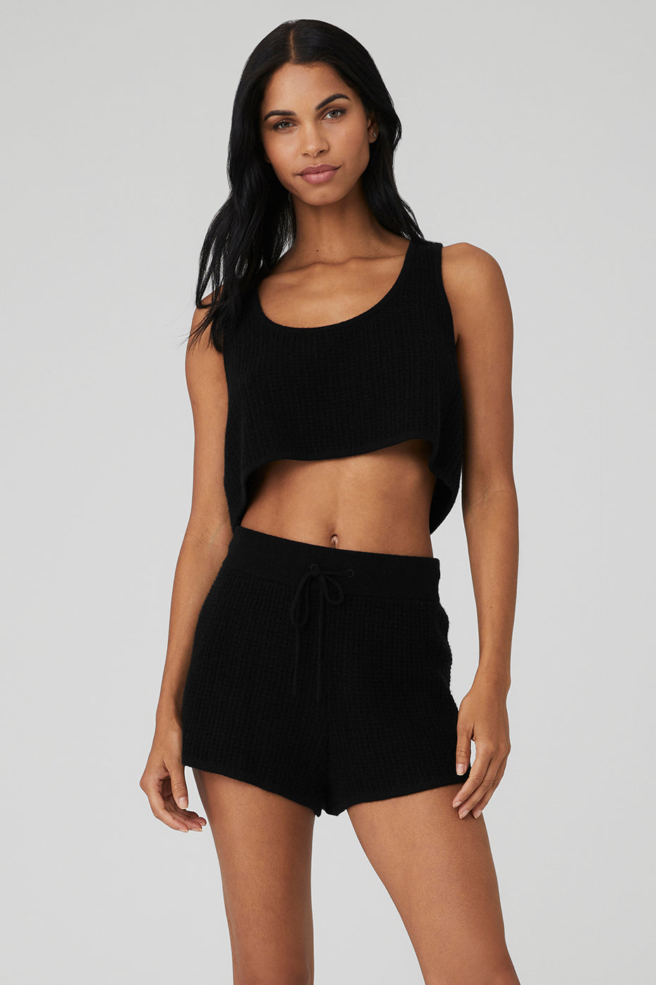 Front view of the luxe cashmere cropped tank top in black, showcasing its scoop neck design.