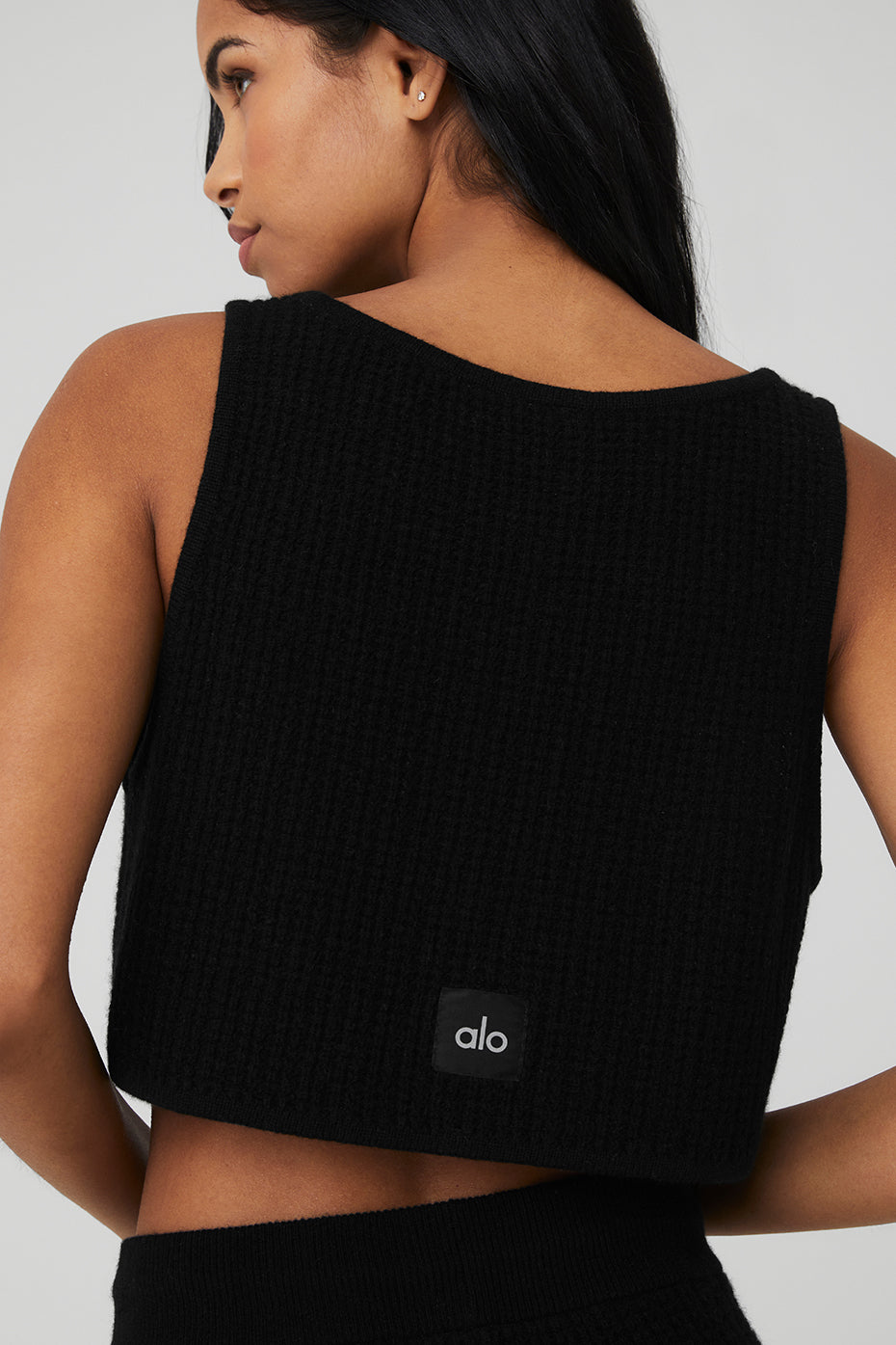 Front view of the luxe cashmere cropped tank top in black, showcasing its scoop neck design.