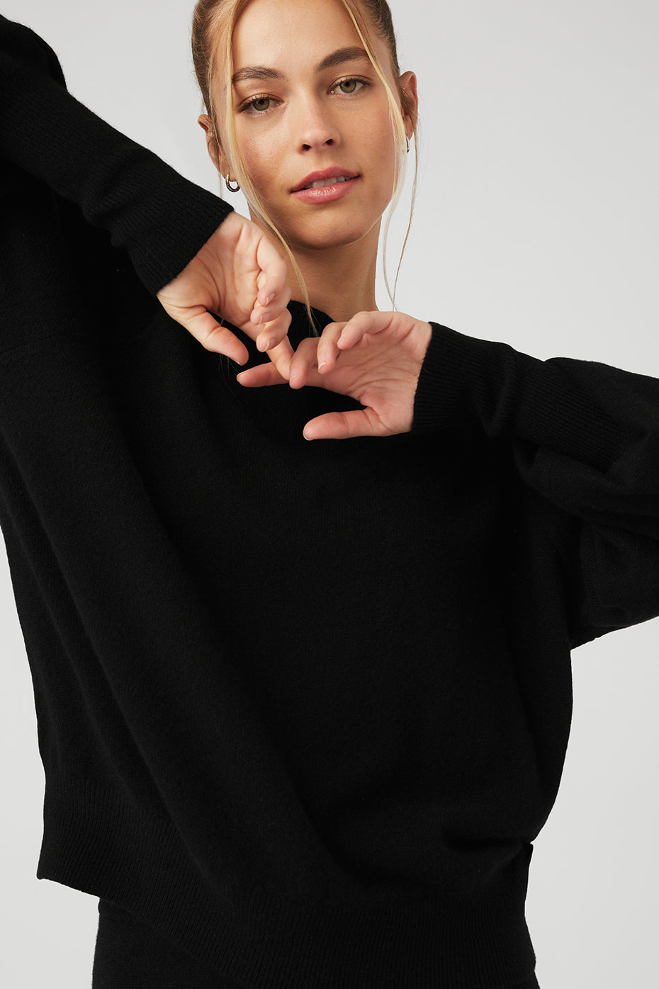Front view of black crewneck cashmere sweater styled with matching pants