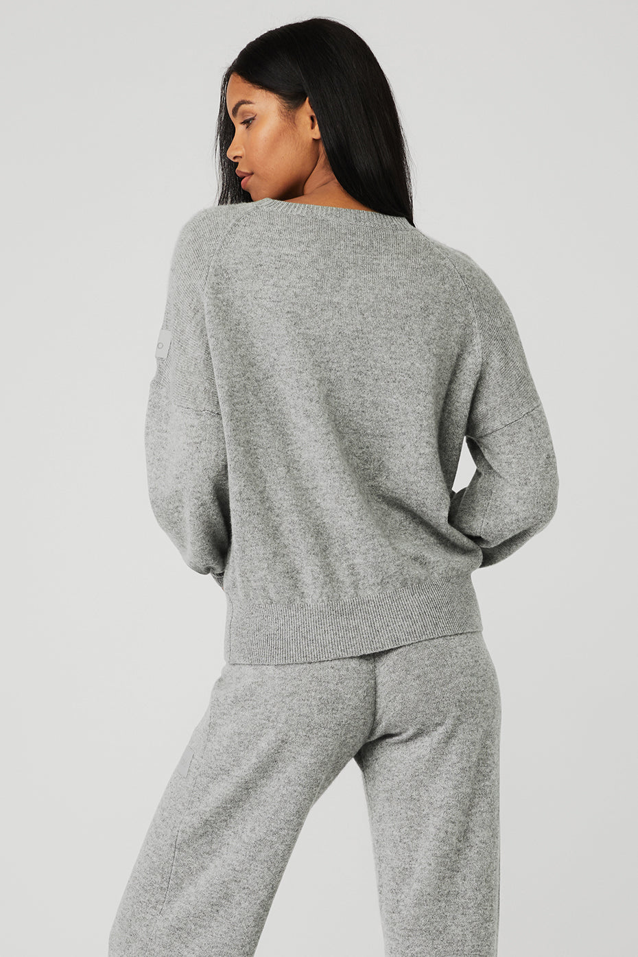 Model wearing a grey cashmere cardigan during a casual outing
