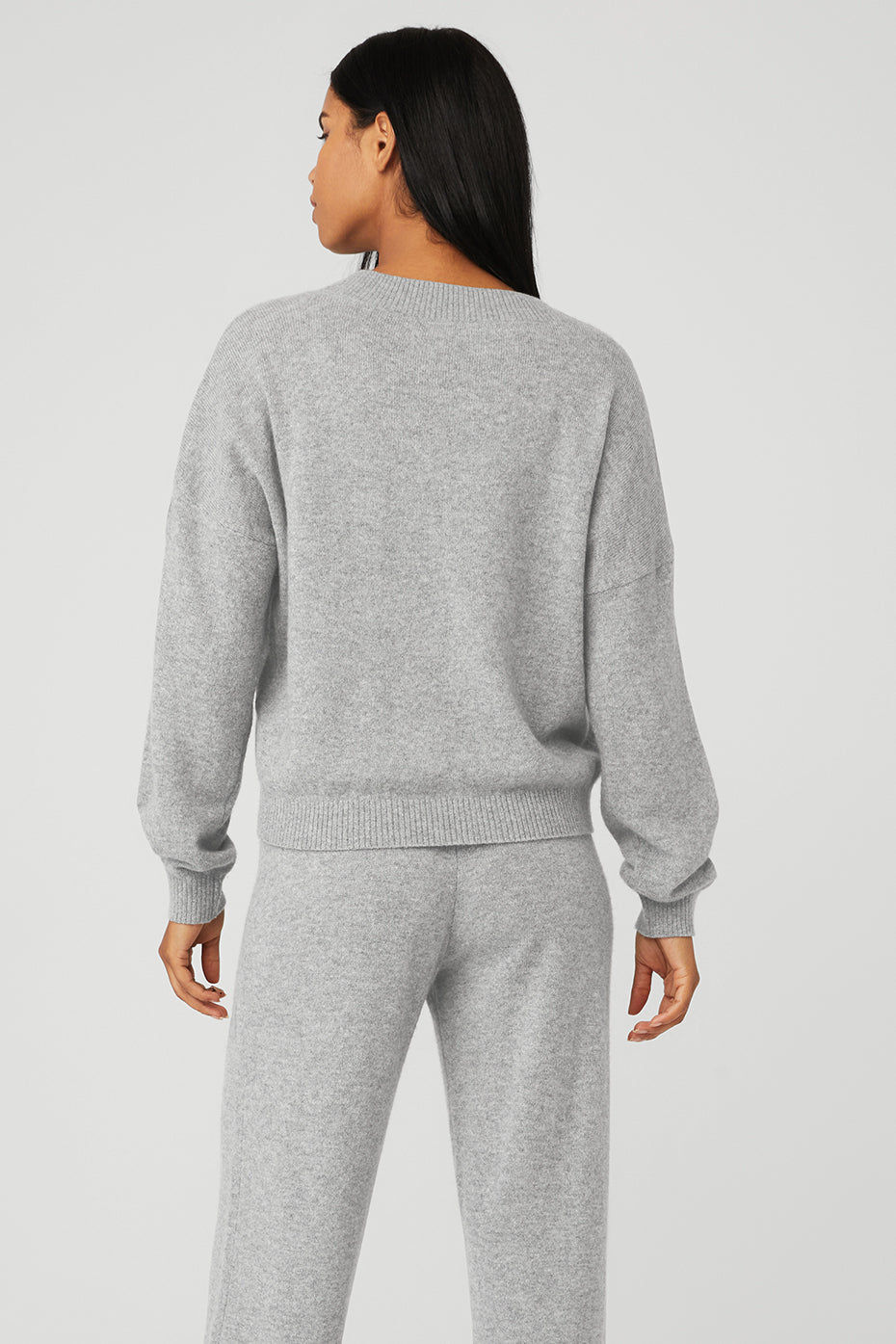 Side profile showcasing the V-neck pullover fit and ribbed cuffs