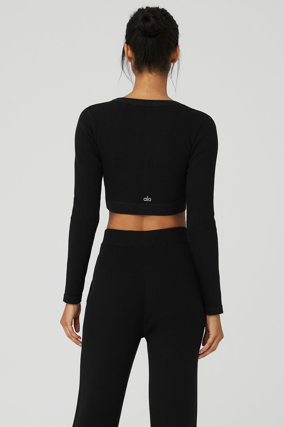 Detail shot of the curved hem and ribbed fabric of the crop top