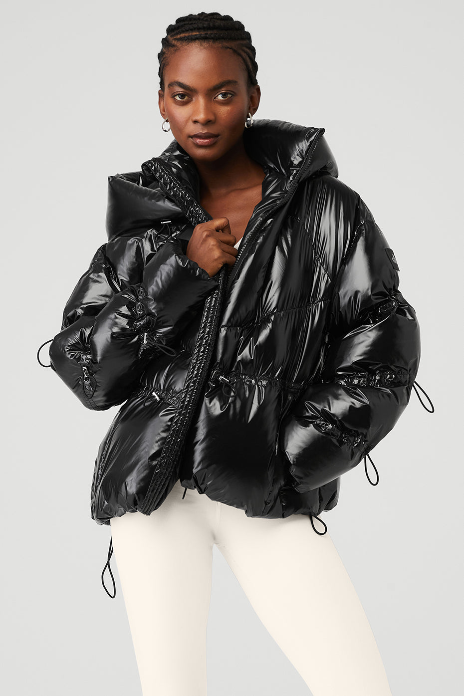 Front view of the sleek black puffer jacket showcasing its glossy finish and tall collar.