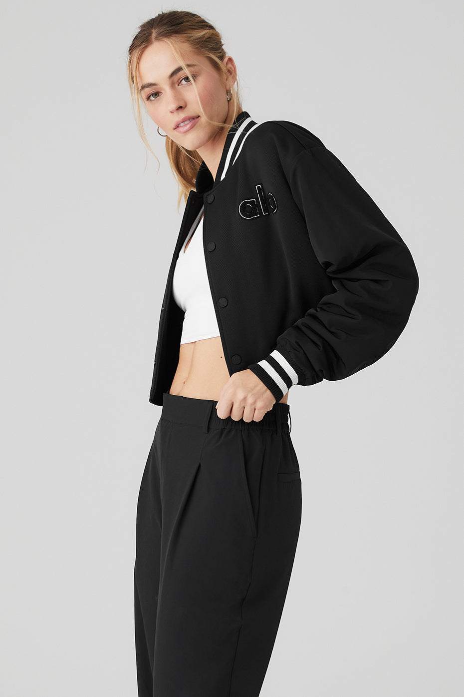 Close-up of the cropped denim jacket highlighting its textured fabric and ribbed cuffs.