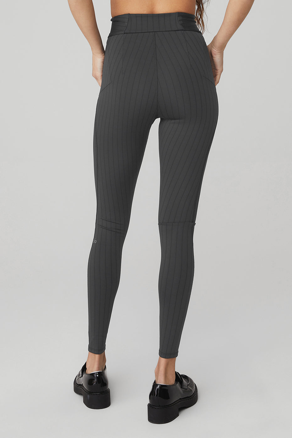 Model wearing high-waisted fitness leggings with a matching sports bra