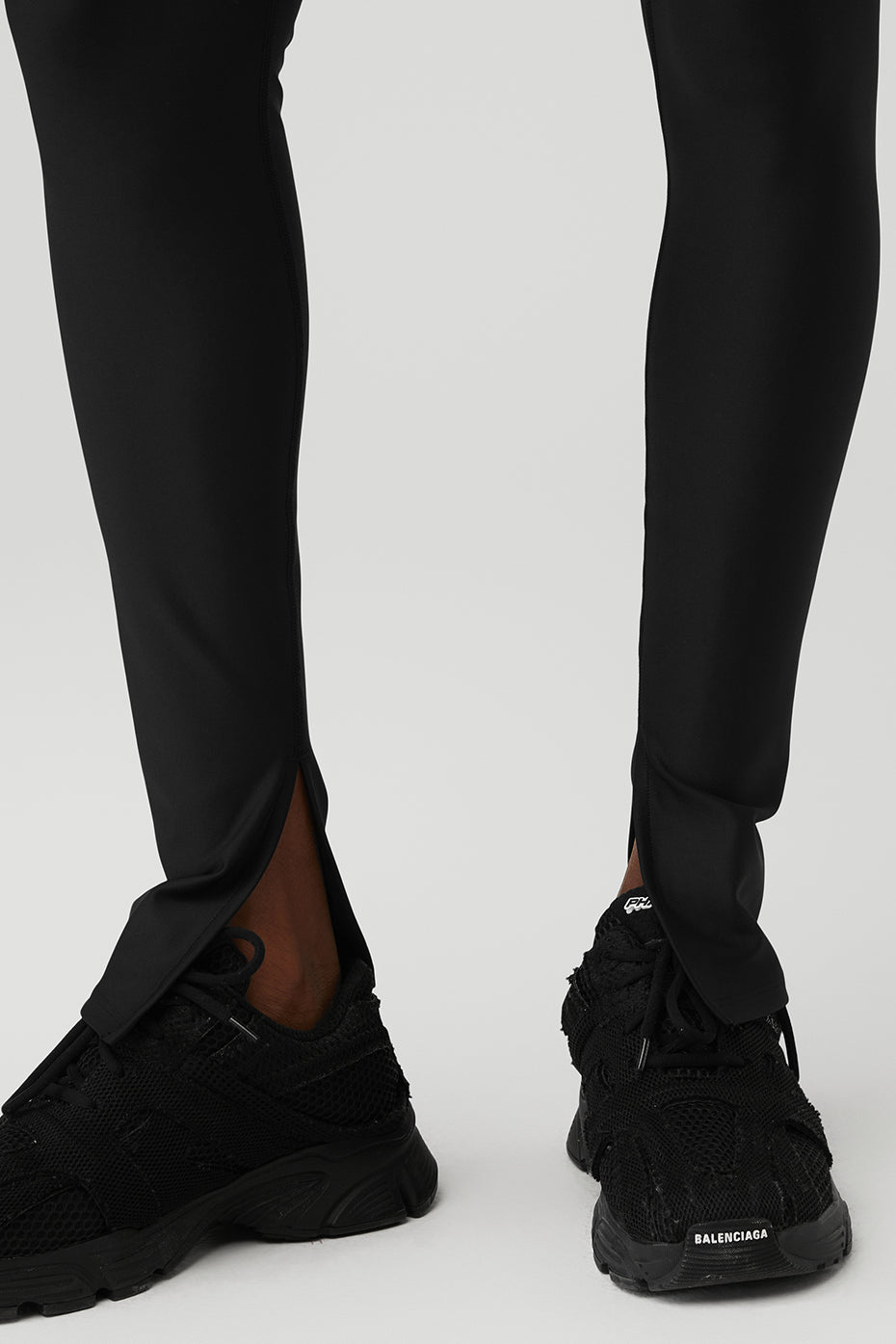 Front angle of black elongated leggings showcasing high waist fit