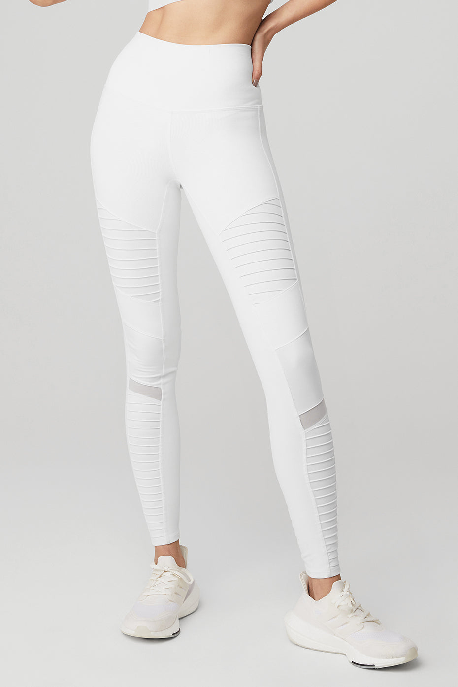 Front view of high-waisted moto leggings in glossy white for studio workouts