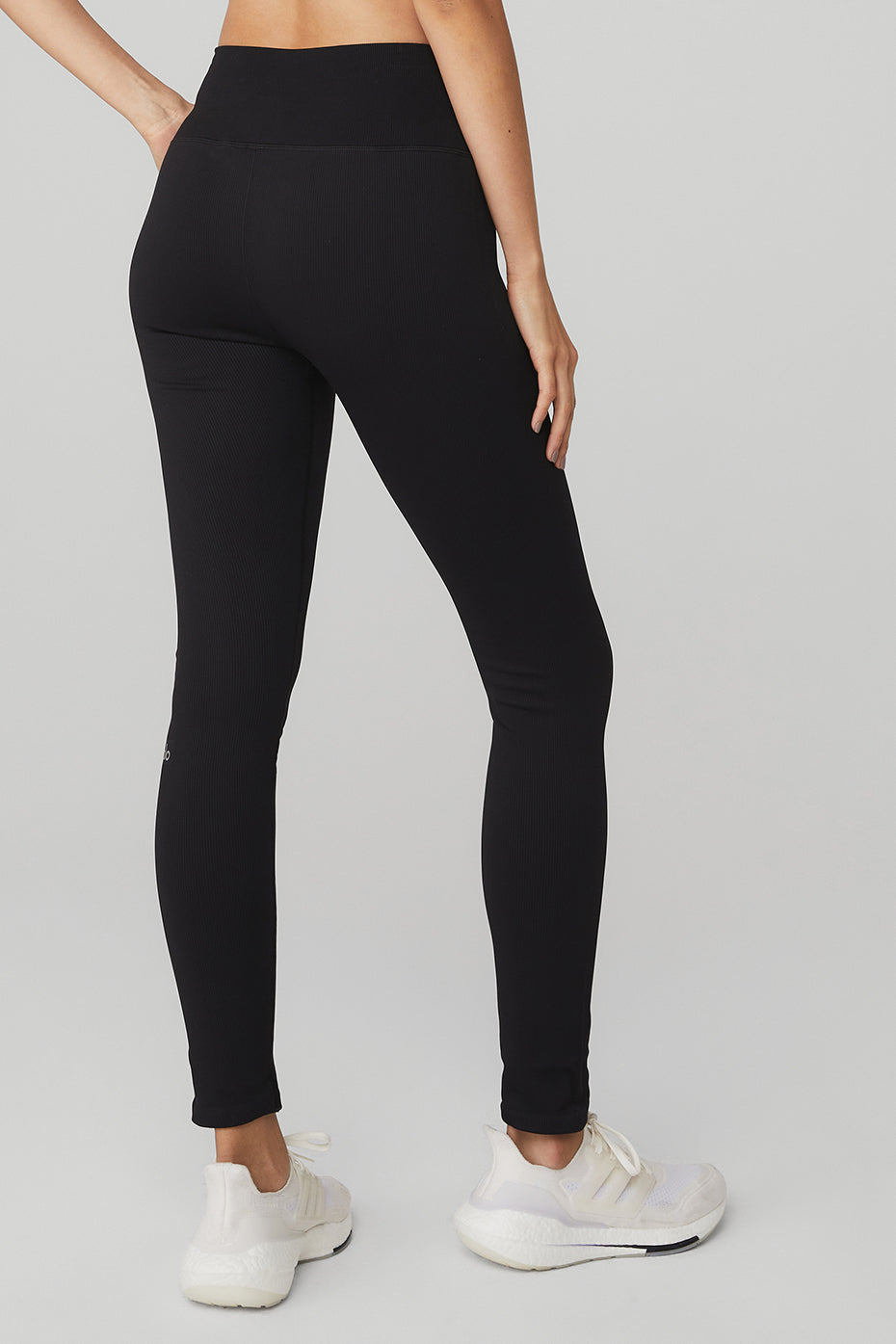 Model wearing black leggings with a matching sports bra, perfect for studio workouts