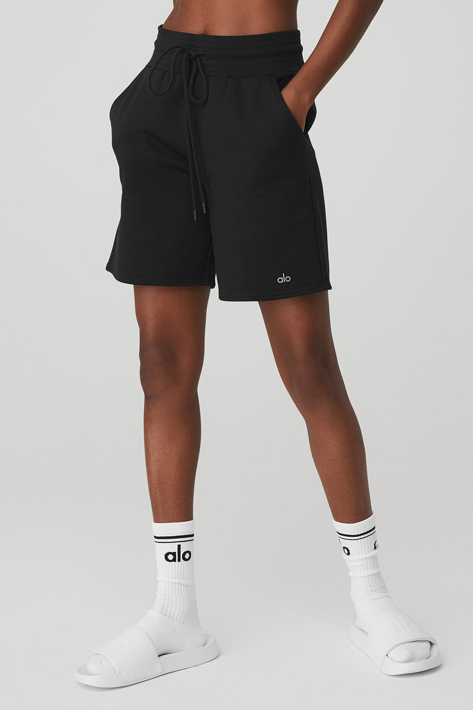 Model wearing mens sweat shorts alternative fit in lounge-ready setting