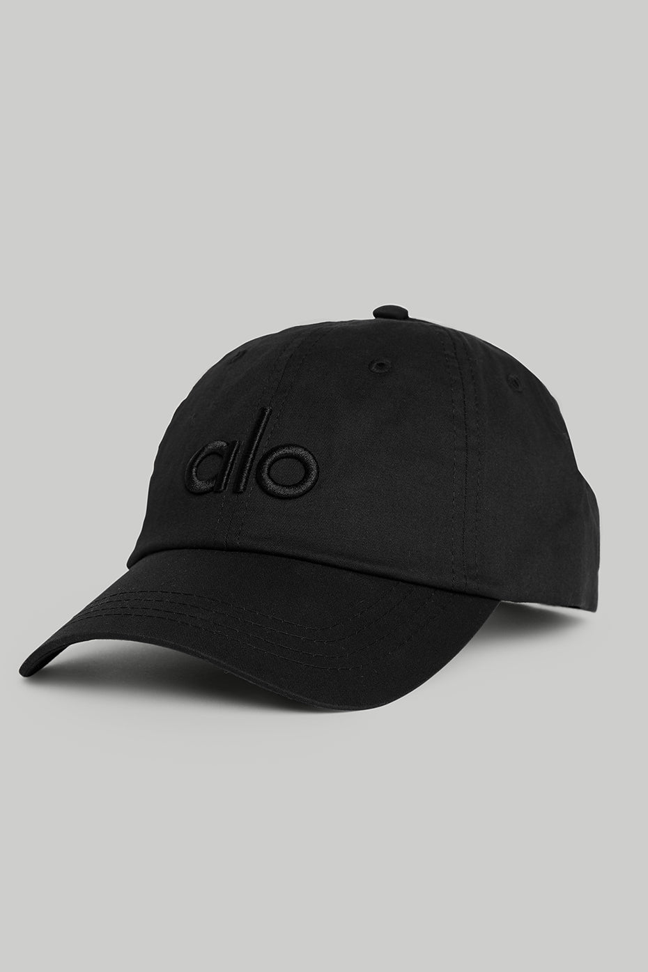 Close-up of men's black dad cap showing logo detail