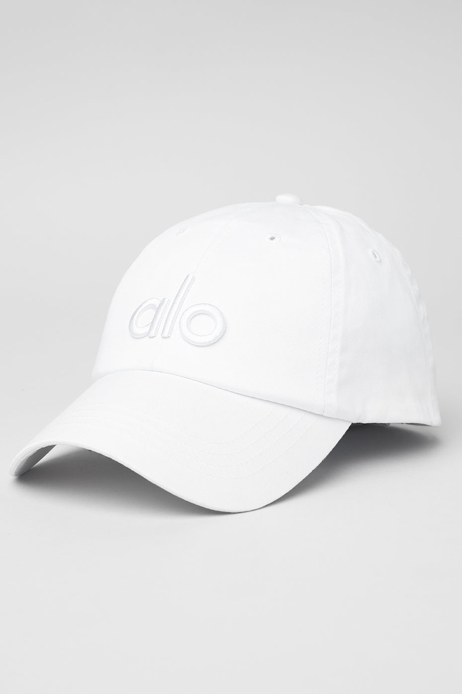 Front view of the bright white dad cap showcasing the logo