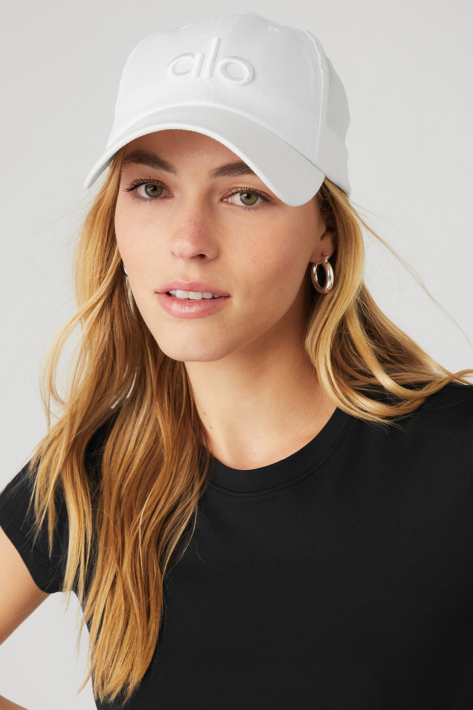 Front view of the bright white dad cap showcasing the logo
