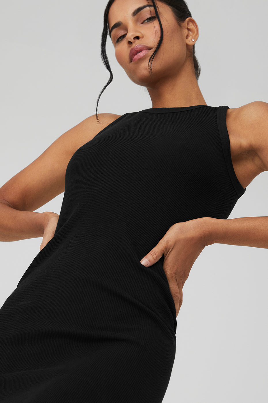 Close-up of the ribbed texture and contouring fit of the black bodycon dress