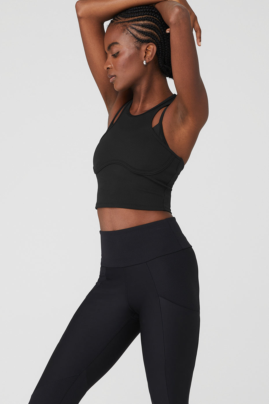 Model wearing the Airlift Ribbed Bra Tank Top during a yoga session.