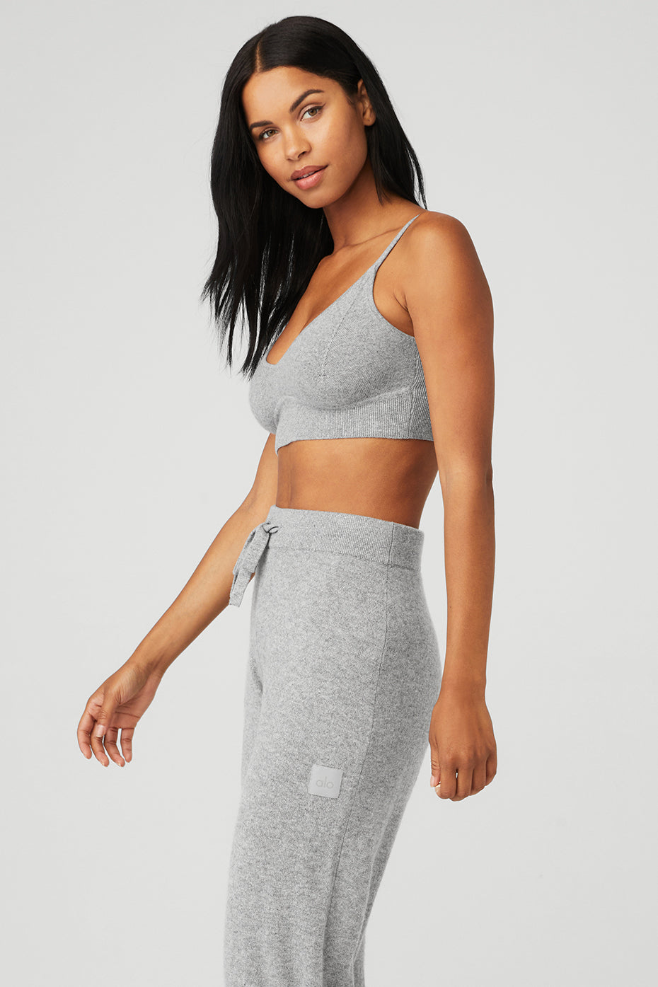 Lifestyle shot featuring the Jet Set Cashmere Bra styled with matching cashmere pants and sweater.