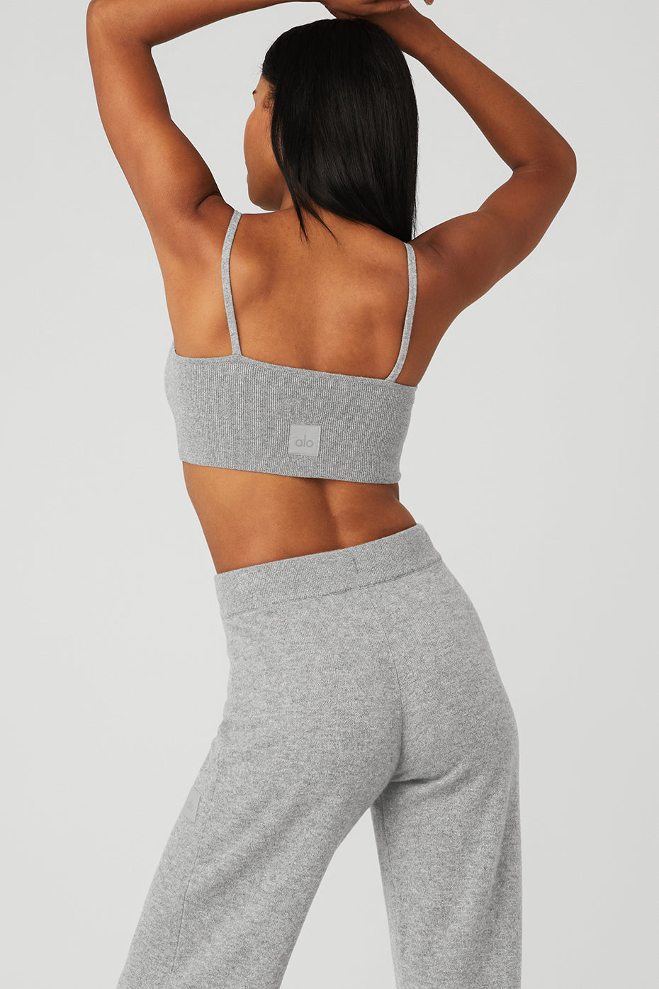 Side angle of the cashmere bra, emphasizing the delicate straps and deep V-neck design.